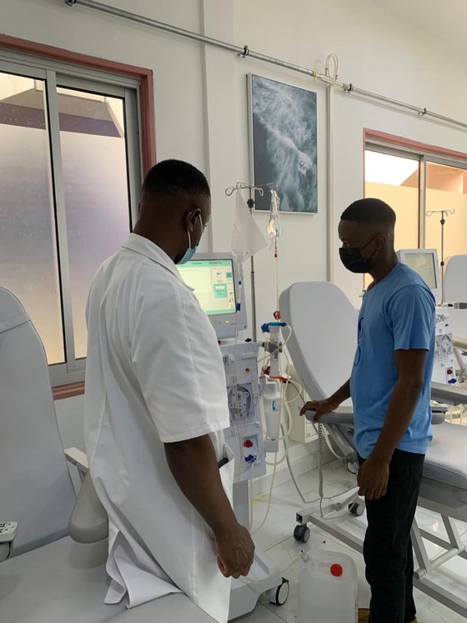 Clinician demonstrating a hemodialysis machine to a Gima-Bambot technician at the hemodialysis centre in Douala
