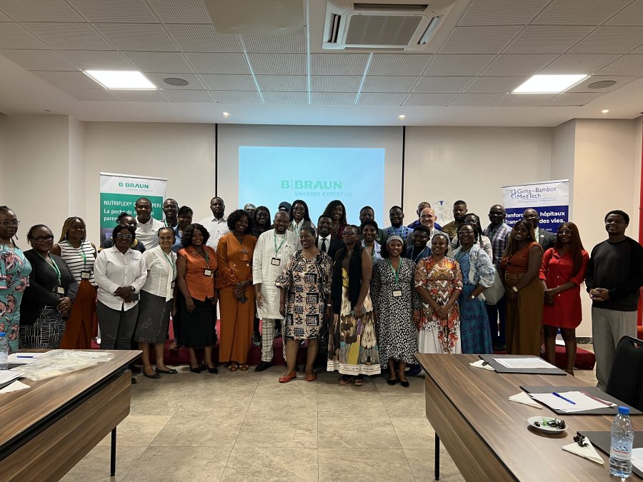 Group photo of healthcare professionals at a B. Braun and Gima-Bambot MedTech Ltd. training event in Douala, Cameroon, with B. Braun and Gima-Bambot banners